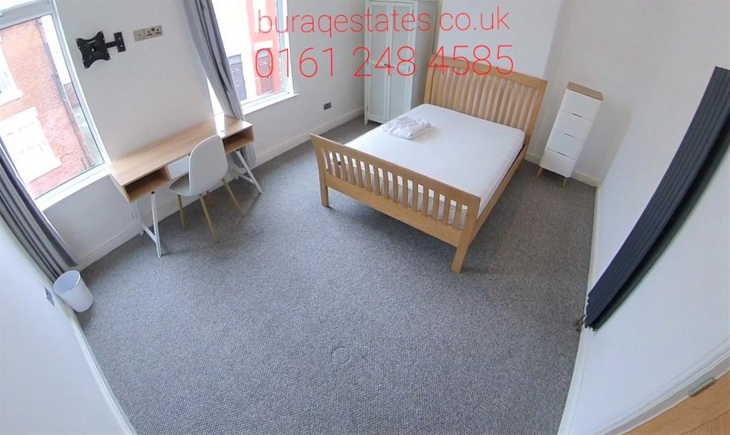 Bright, neatly presented bedroom with a wooden ...
