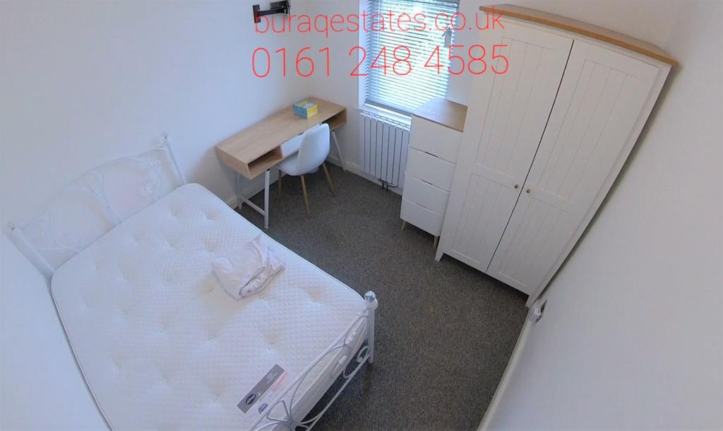 Bright, simply furnished small bedroom with a s...