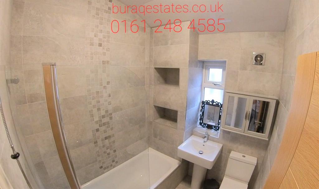 Modern bathroom with a bath and overhead shower...