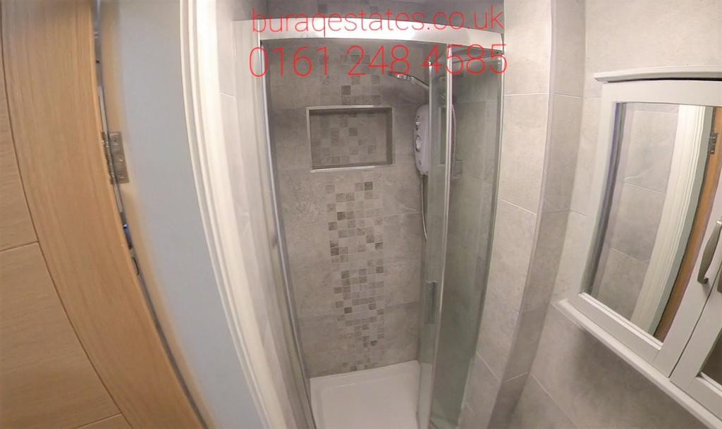 Modern shower cubicle with patterned tile accen...