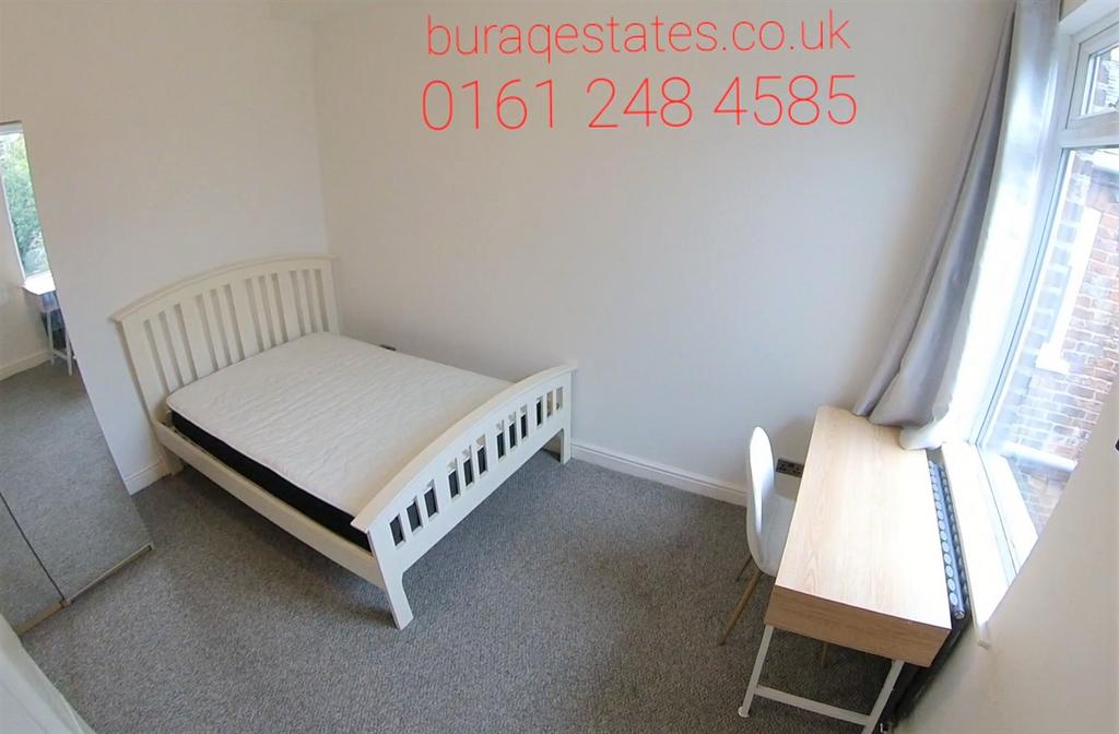 Bright, simply furnished bedroom with a white b...