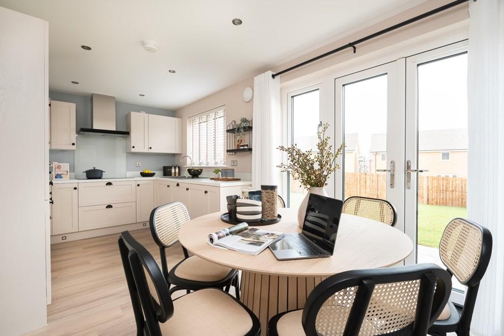A modern kitchen and dining area with French...