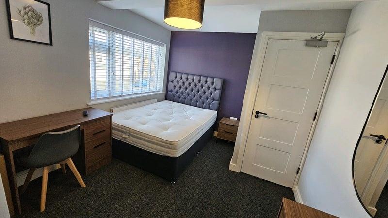 Bright, modern bedroom with a comfortable doubl...