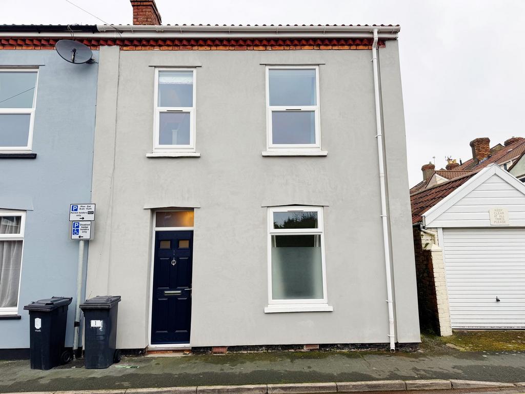 Street-facing terraced house with a modern grey...