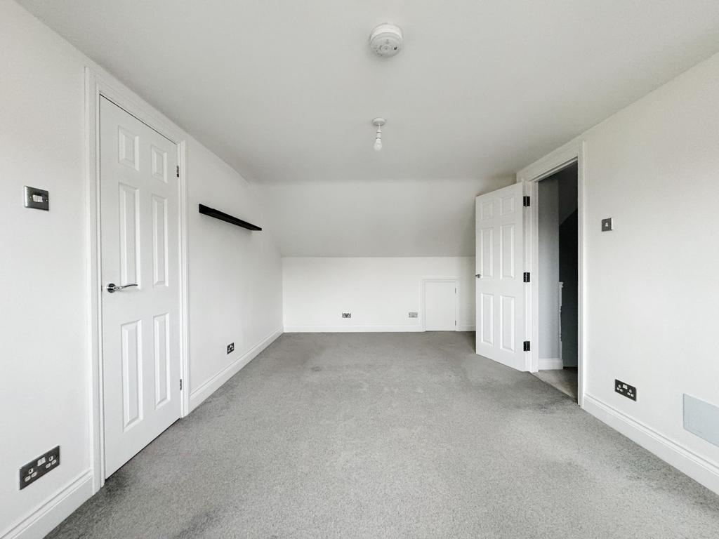 Bright, neutral double bedroom with fresh white...