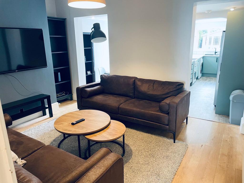 Bright, modern living room with matching brown ...
