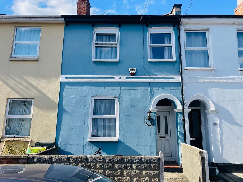 Bright blue-painted terraced house with white t...