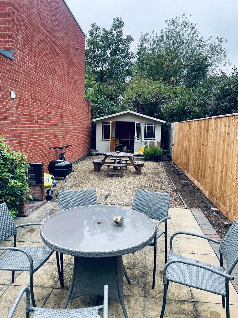 Private rear garden with a paved patio dining a...