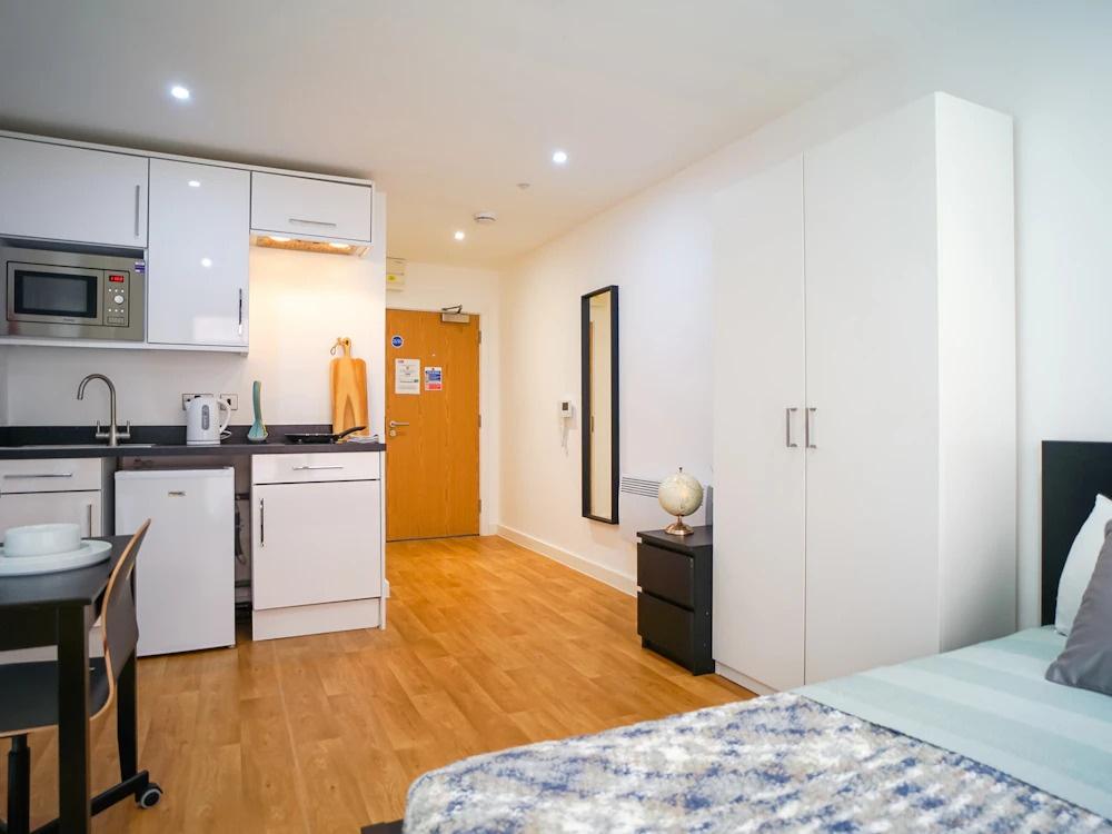 Bright, modern studio room with a fitted kitche...