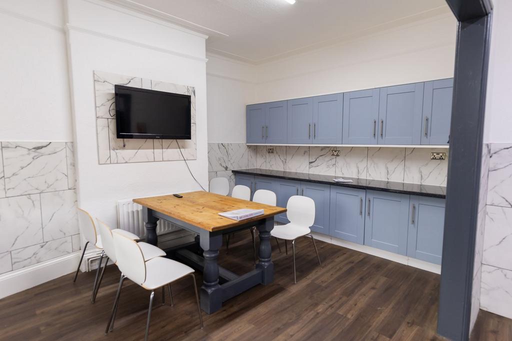 Bright and clean kitchen with light blue cabine...