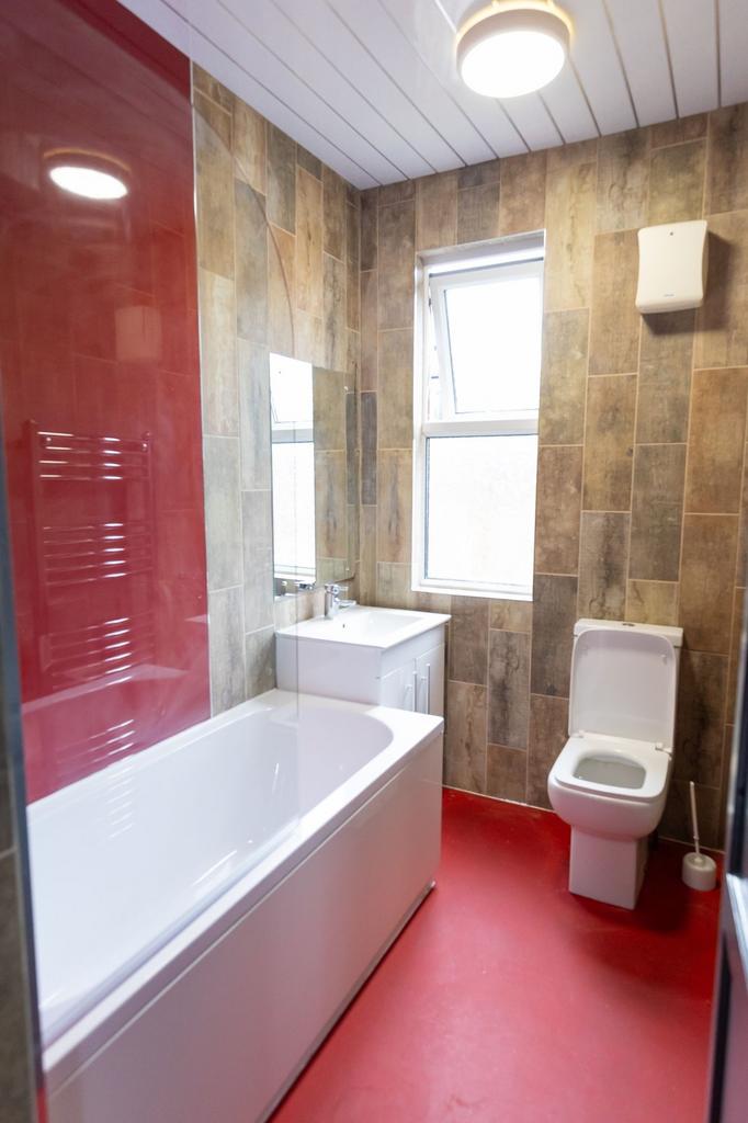 Modern bathroom featuring a large bathtub with ...