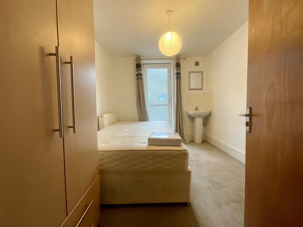 Bright, simply furnished bedroom with built-in ...