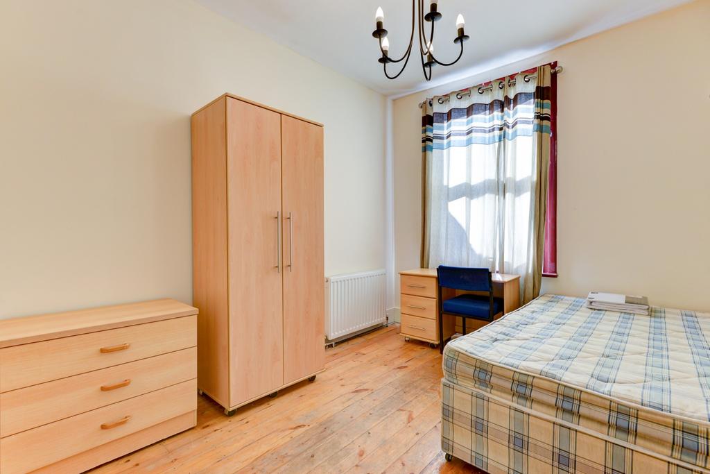 Bright, neatly presented bedroom with wood-effe...