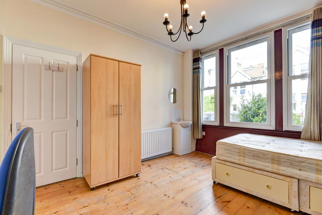 A bright and airy bedroom featuring large windo...