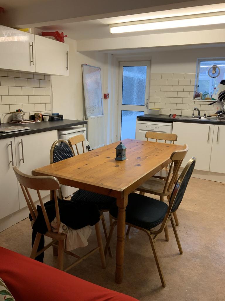 Bright, well-equipped kitchen with modern white...