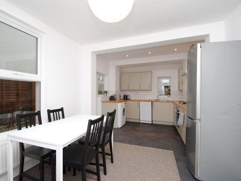 Bright open-plan kitchen and dining area with a...