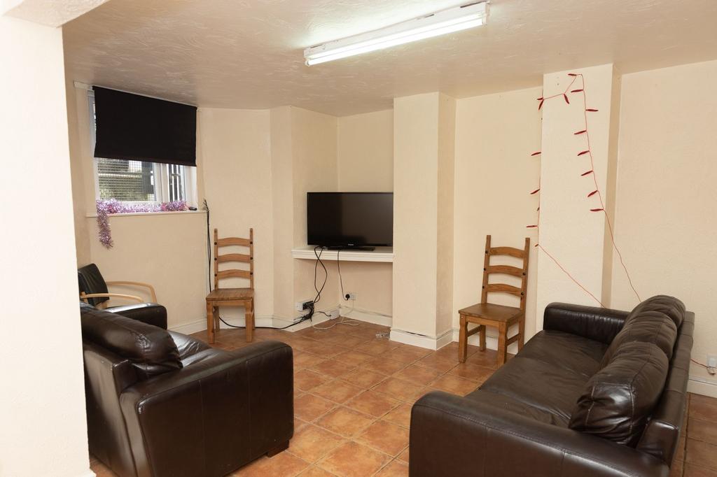 A cozy living room featuring two leather sofas,...
