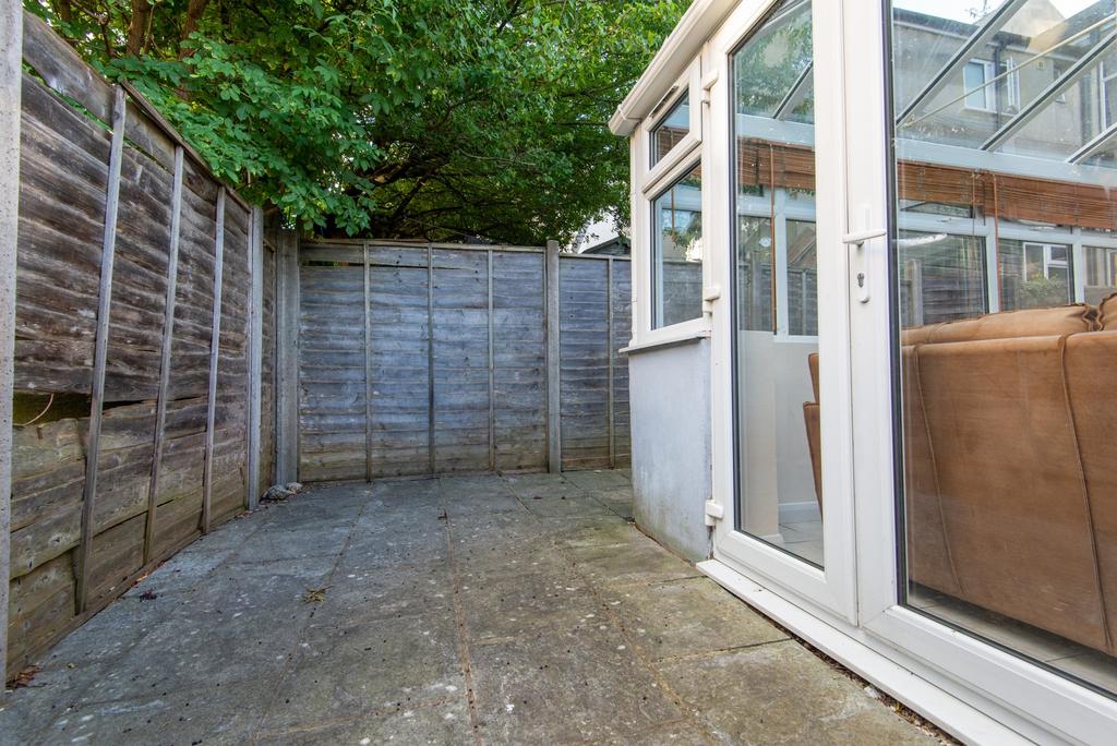 Private paved courtyard with high fence for pri...