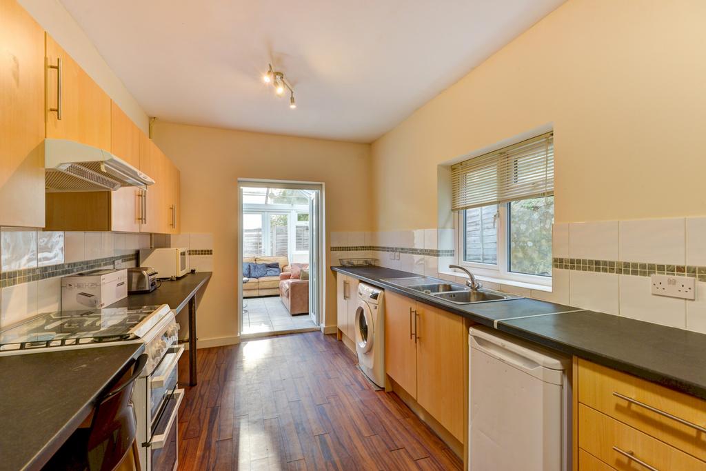 A bright, clean kitchen featuring modern cabine...