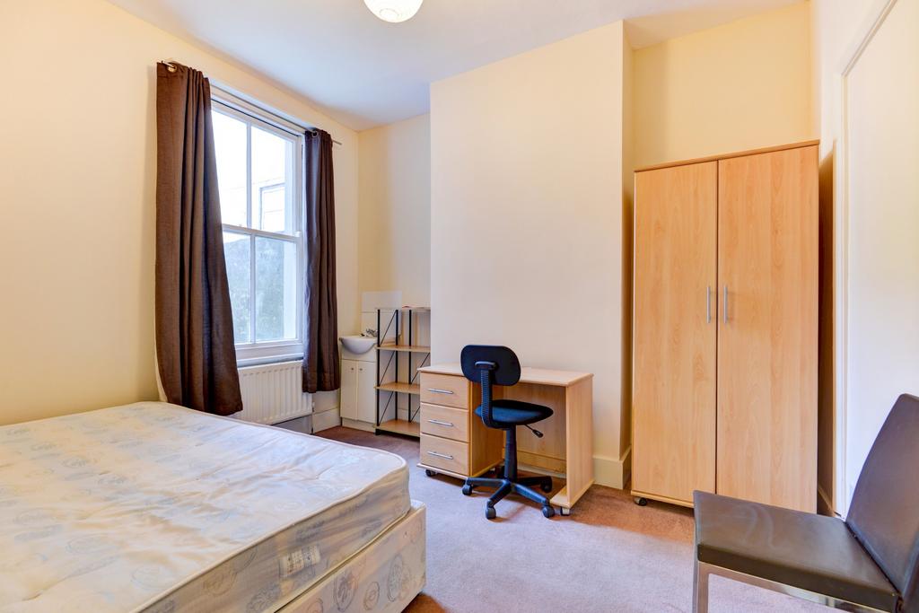 Bright, tidy bedroom with a comfortable bed, fu...