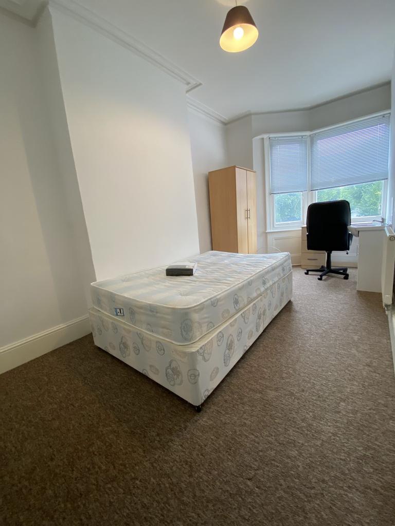 Bright double bedroom with a double mattress on...