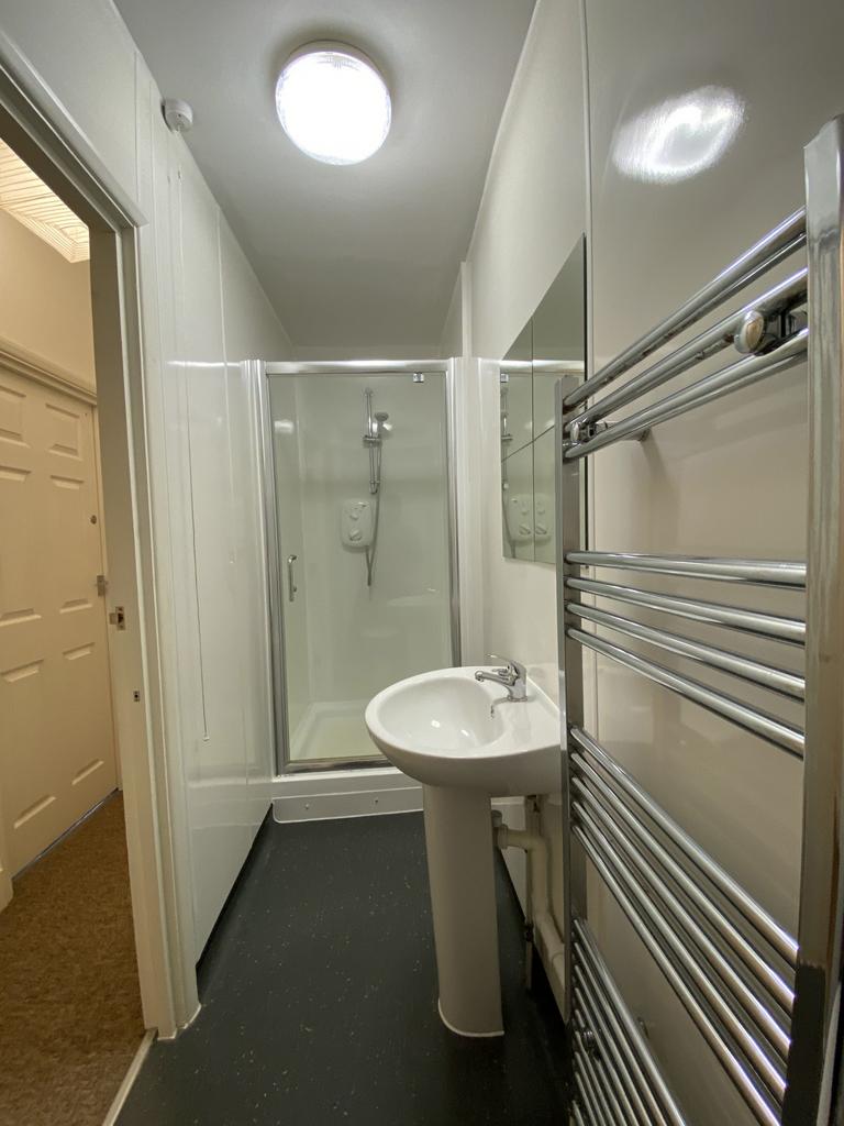 Bright, modern bathroom with a walk-in shower, ...