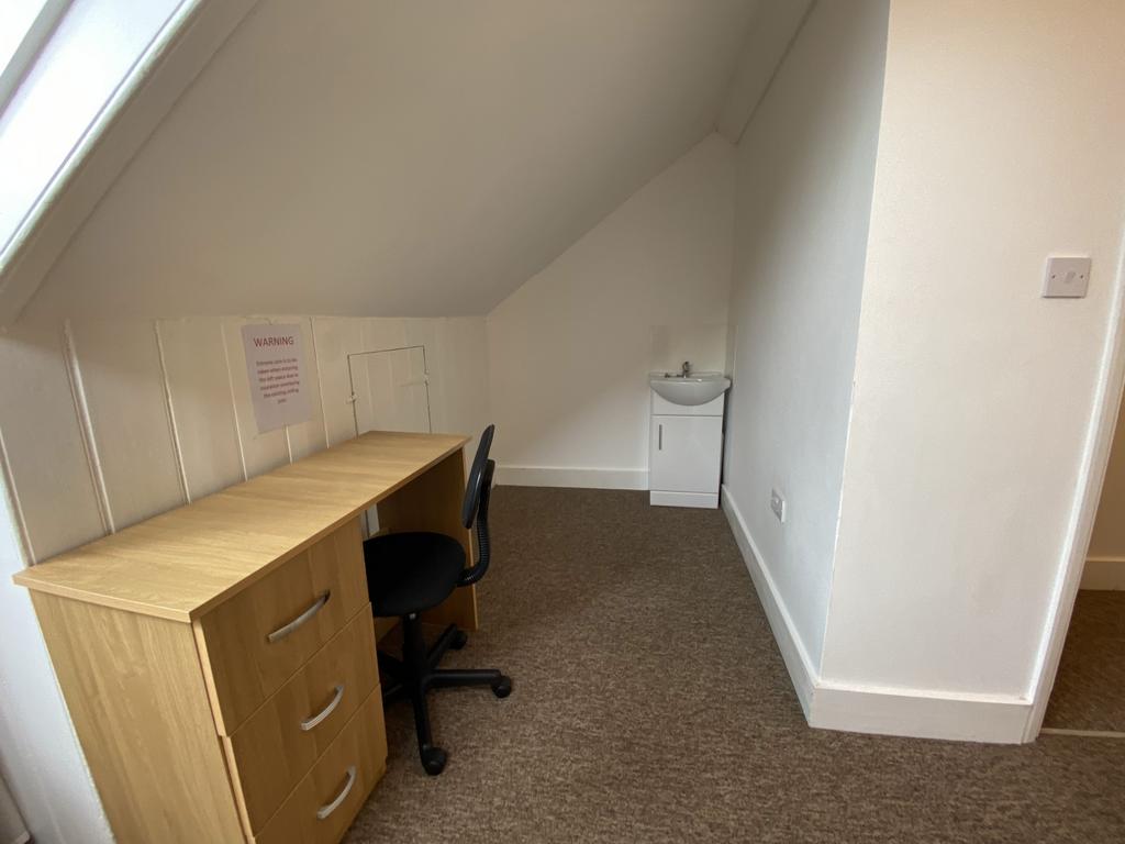 Bright upstairs bedroom with a pitched ceiling,...