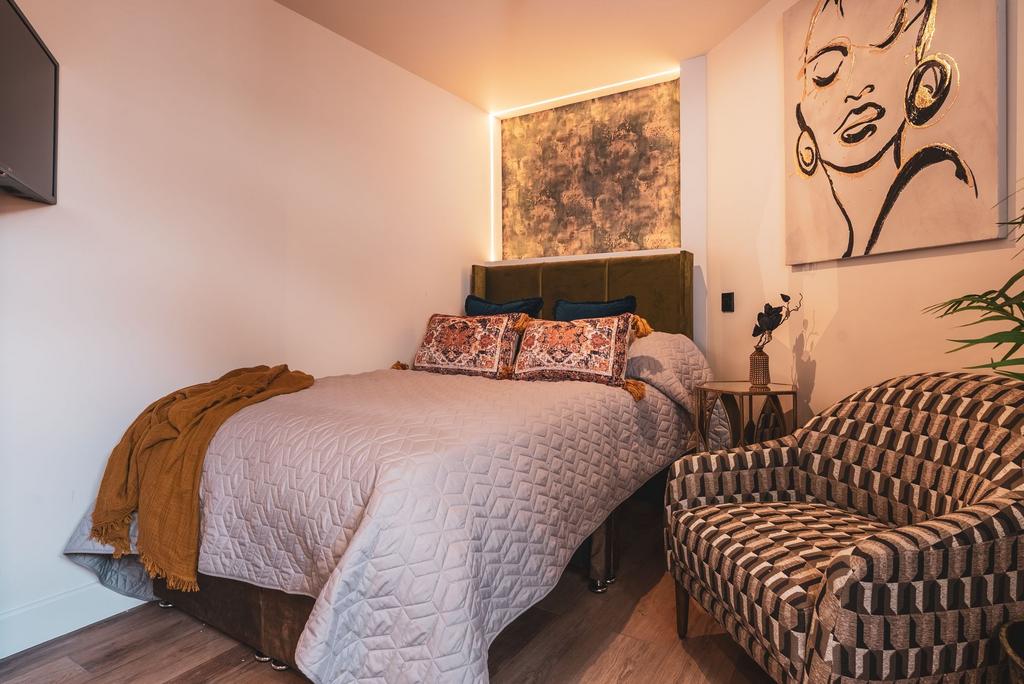 Stylish double bedroom with a plush upholstered...