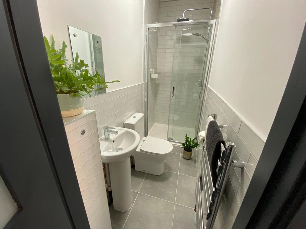 Modern tiled bathroom with a walk-in glass show...
