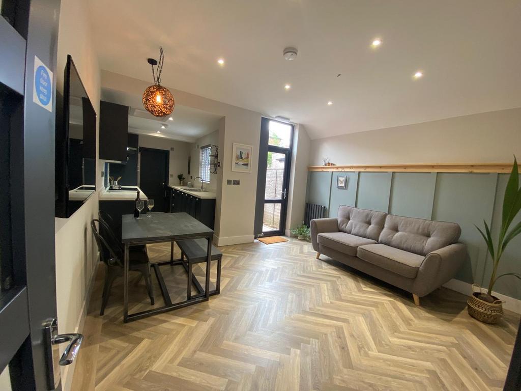 Bright, modern open-plan living area with styli...