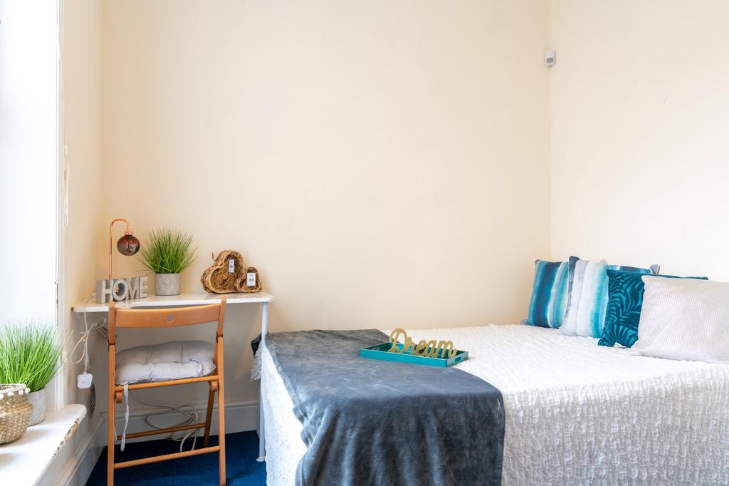 Cozy double bedroom featuring a comfortable bed...