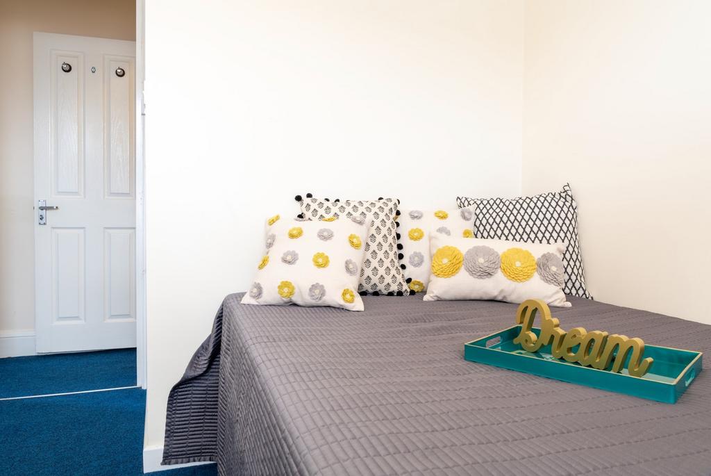 This cozy double bedroom features a comfortable...