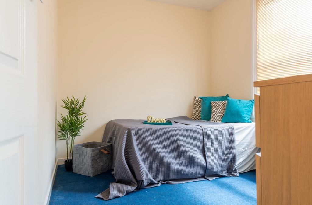 This cozy double bedroom features a comfortable...