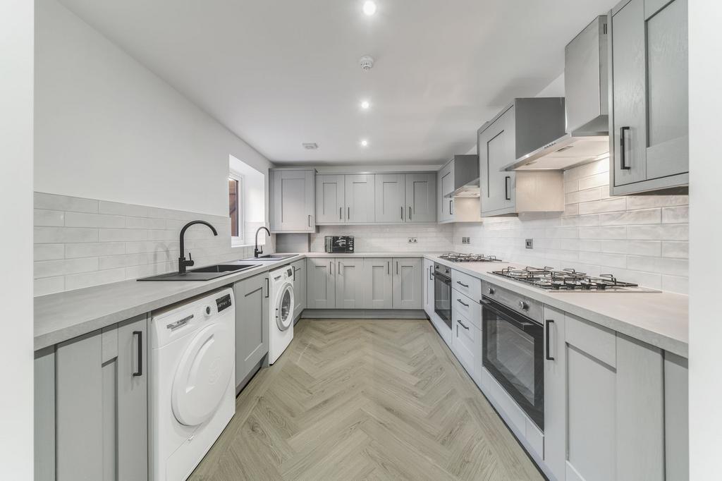 Modern and clean kitchen with light gray cabine...