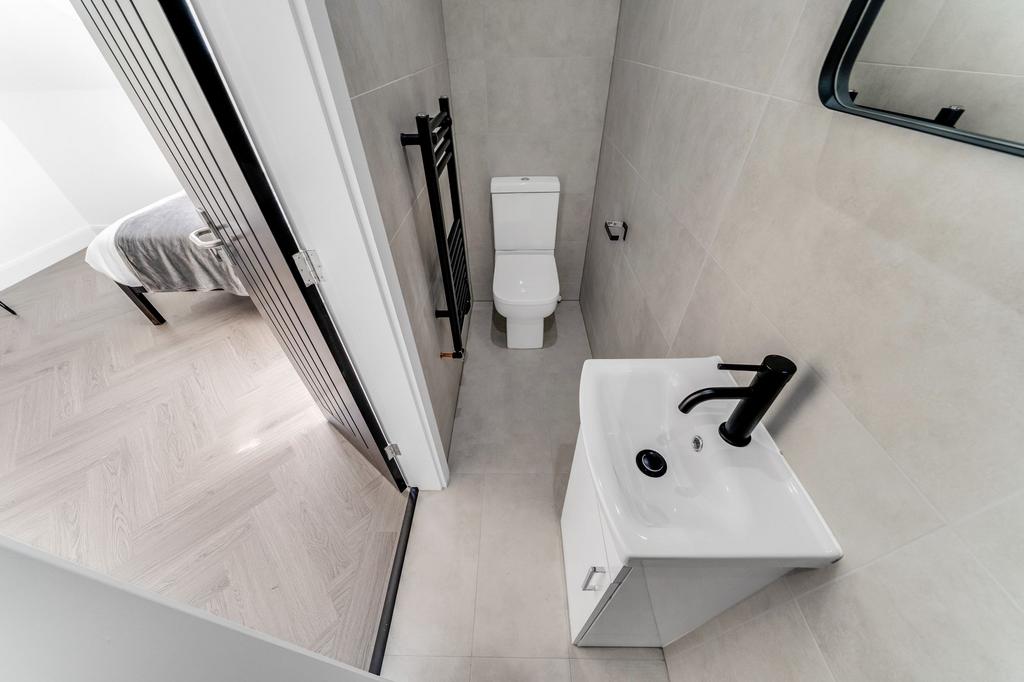 Modern and clean bathroom featuring a white toi...