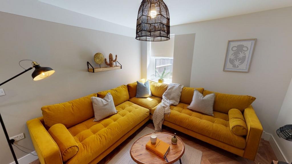 Bright and stylish living room featuring a vibr...