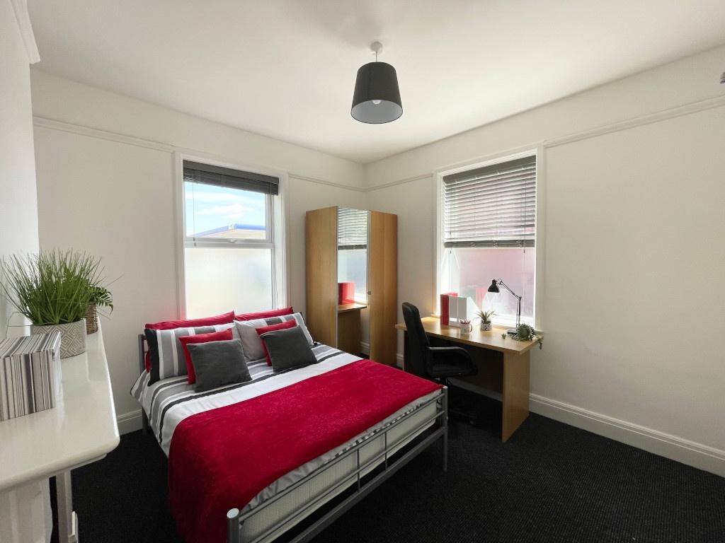 Bright, neatly styled bedroom with a double bed...