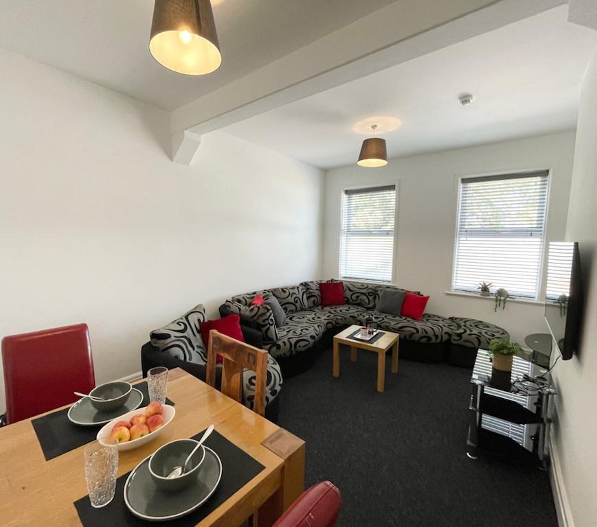 Bright, open living room with a large patterned...