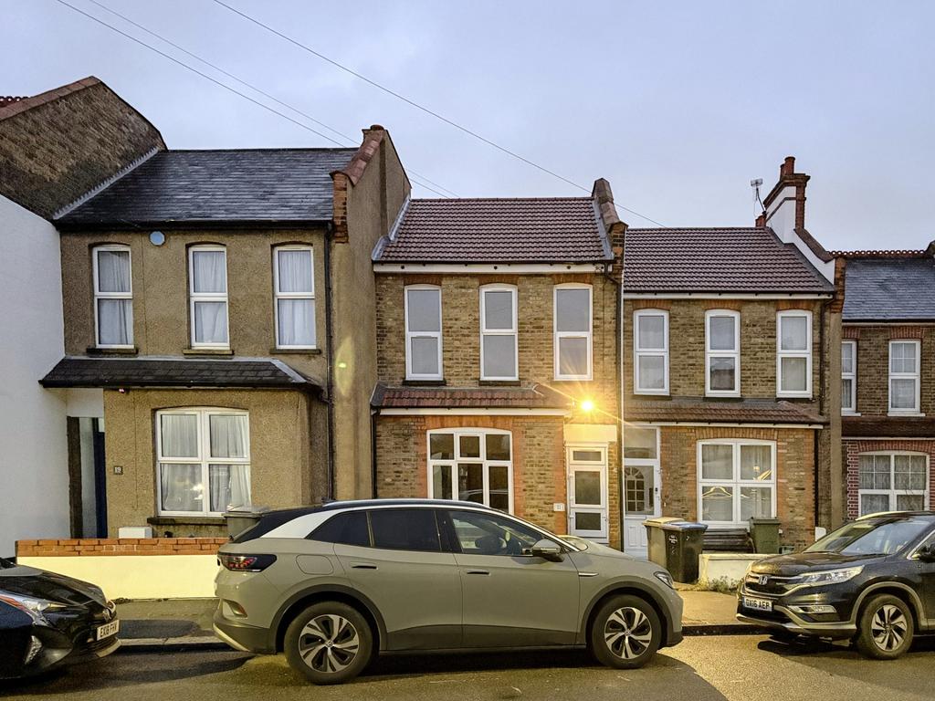 Street-front view of a well-maintained terraced...