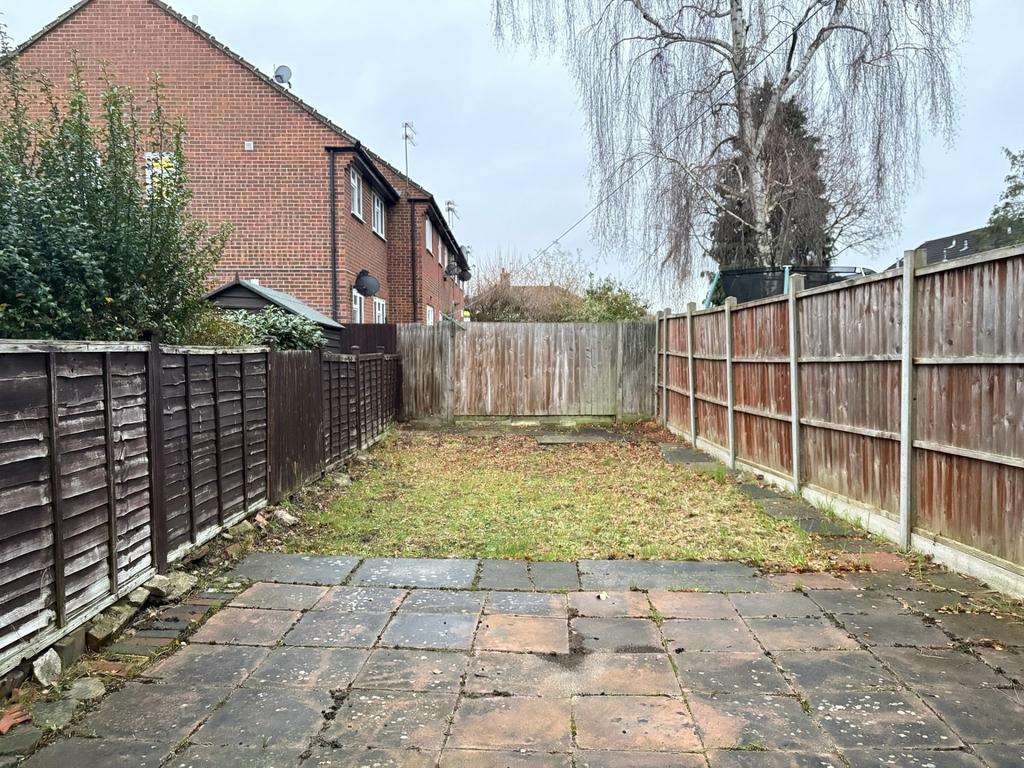 Private rear garden with paved patio leading to...