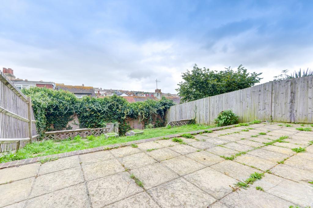 Paved patio leading to a private rear garden wi...