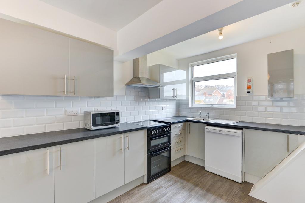 Modern fitted kitchen with light cabinetry, sle...