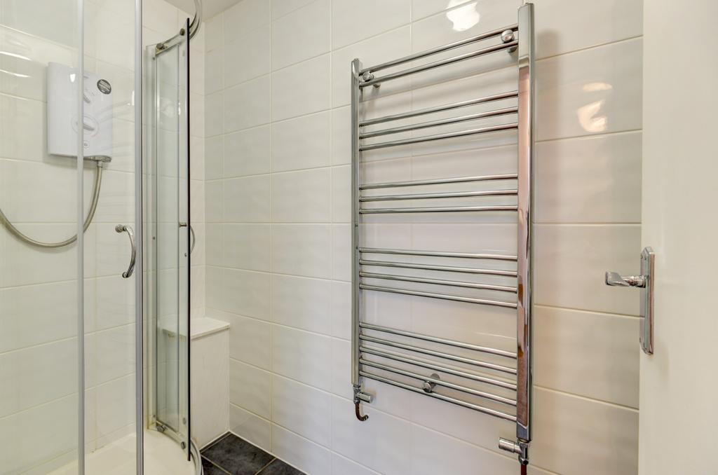 Modern bathroom with a glass-enclosed shower an...
