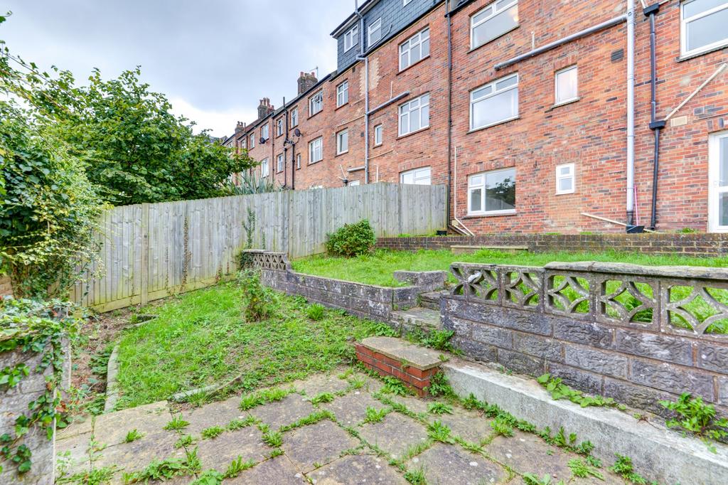 Tiered rear garden with paved patio, raised law...