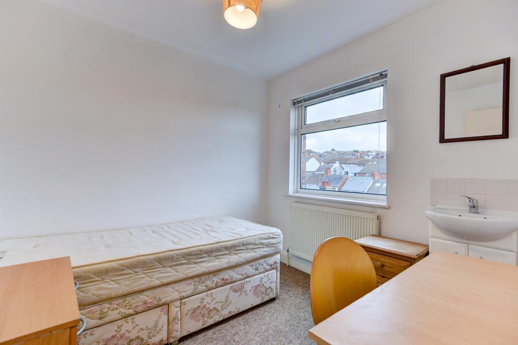 Bright, simply furnished single bedroom with a ...