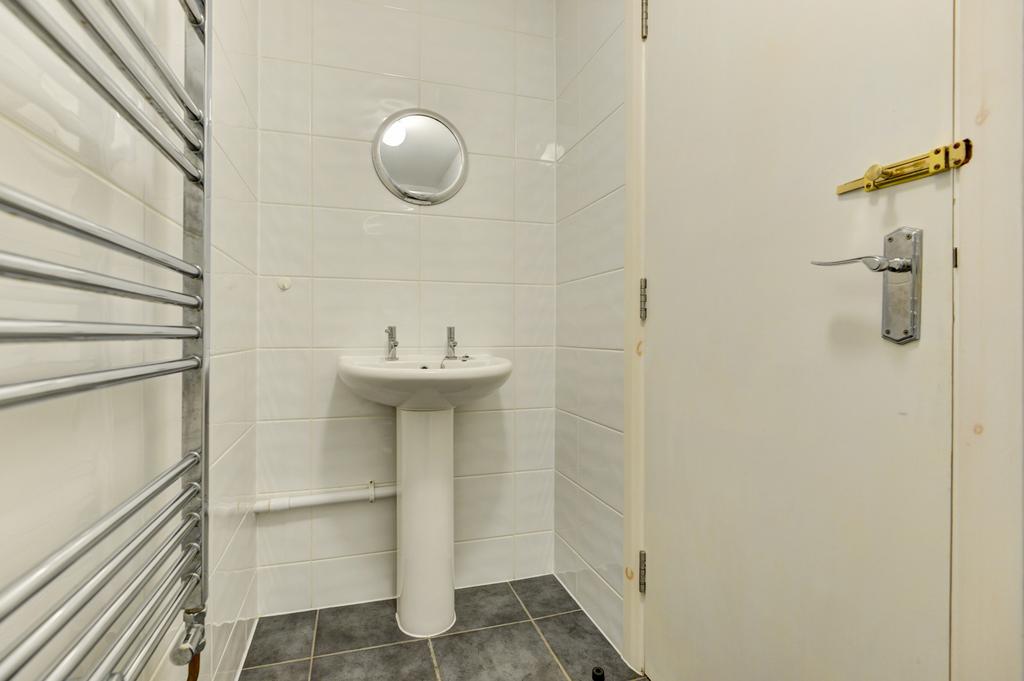 Bright, modern small washroom with a pedestal b...