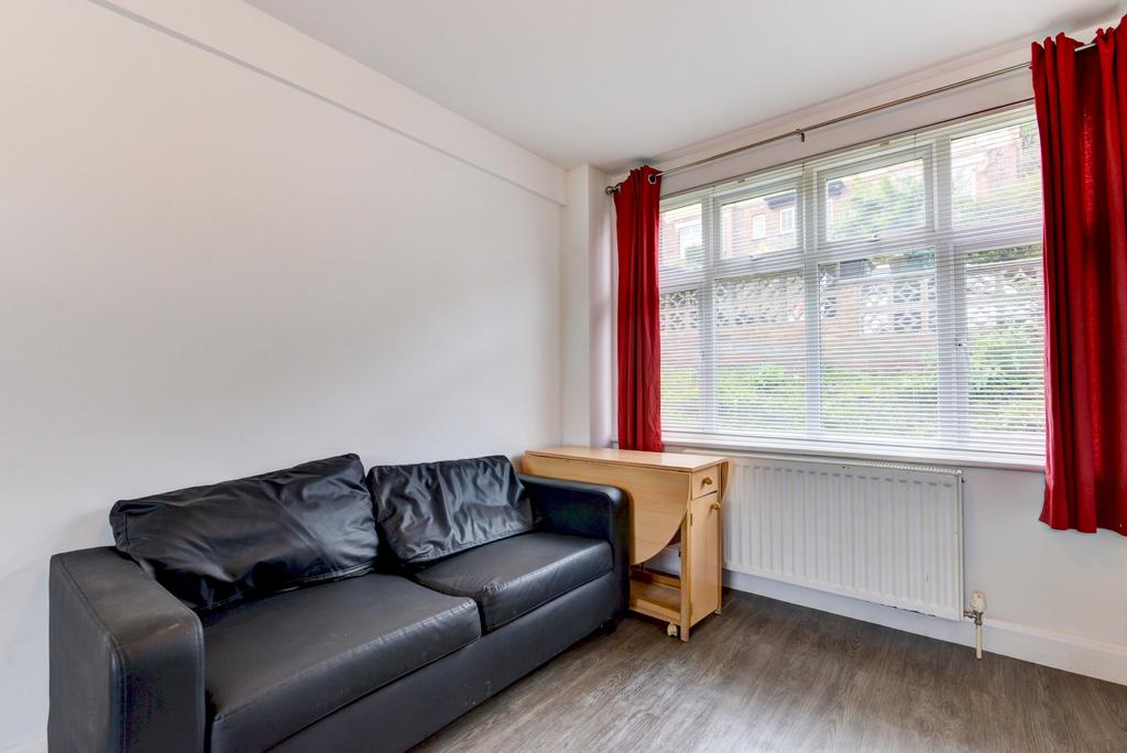 Bright, simply furnished living room with a lar...