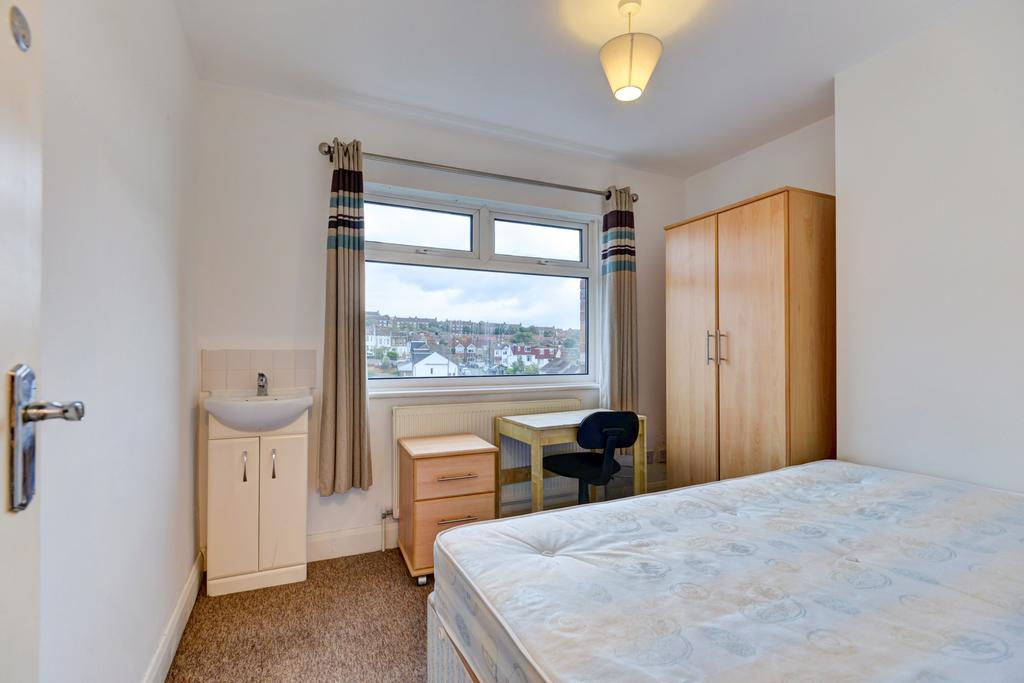 Bright, tidy bedroom with a large window offeri...