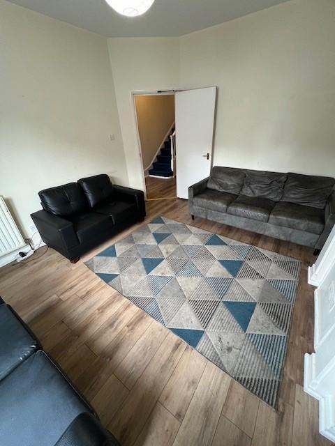 Bright living room with modern laminate floorin...