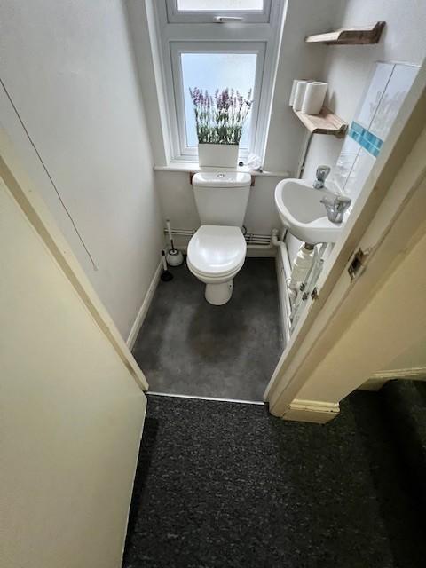 Compact, well-kept WC with a white toilet and c...